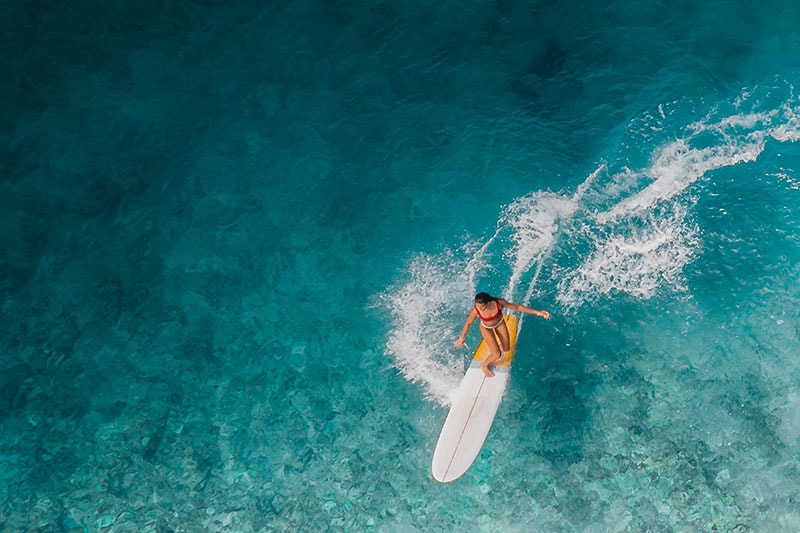 surfer op surfplank op blauwe zee